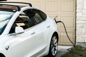 White Tesla Model 3 Charging at Home